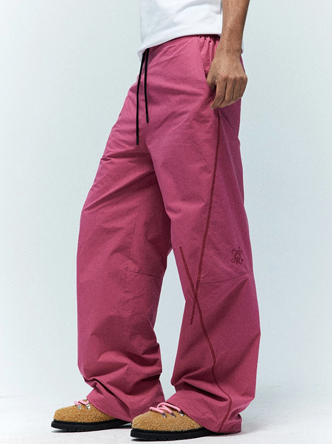 Khaki textured suede Derby shoes with pink laces worn with magenta wide-leg pants