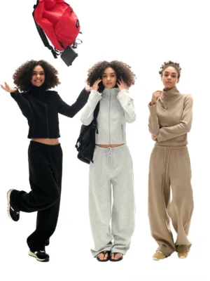 Three color options of cropped high collar zip-up sweatshirt and matching high-waisted sweatpants streetwear set