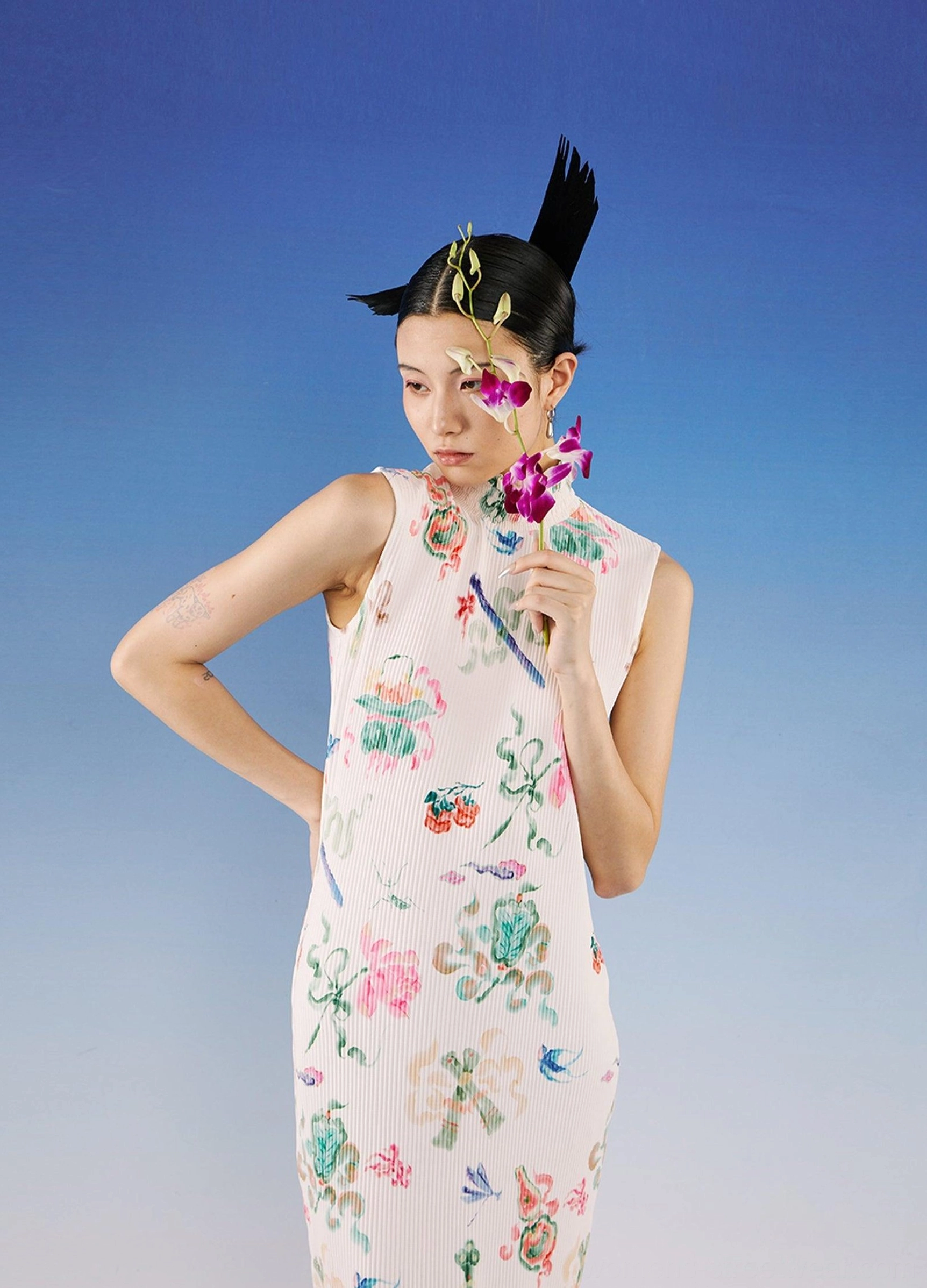 Three-quarter front view of a sleeveless watercolor floral qipao dress with fitted silhouette, stand collar, and artistic flower pattern