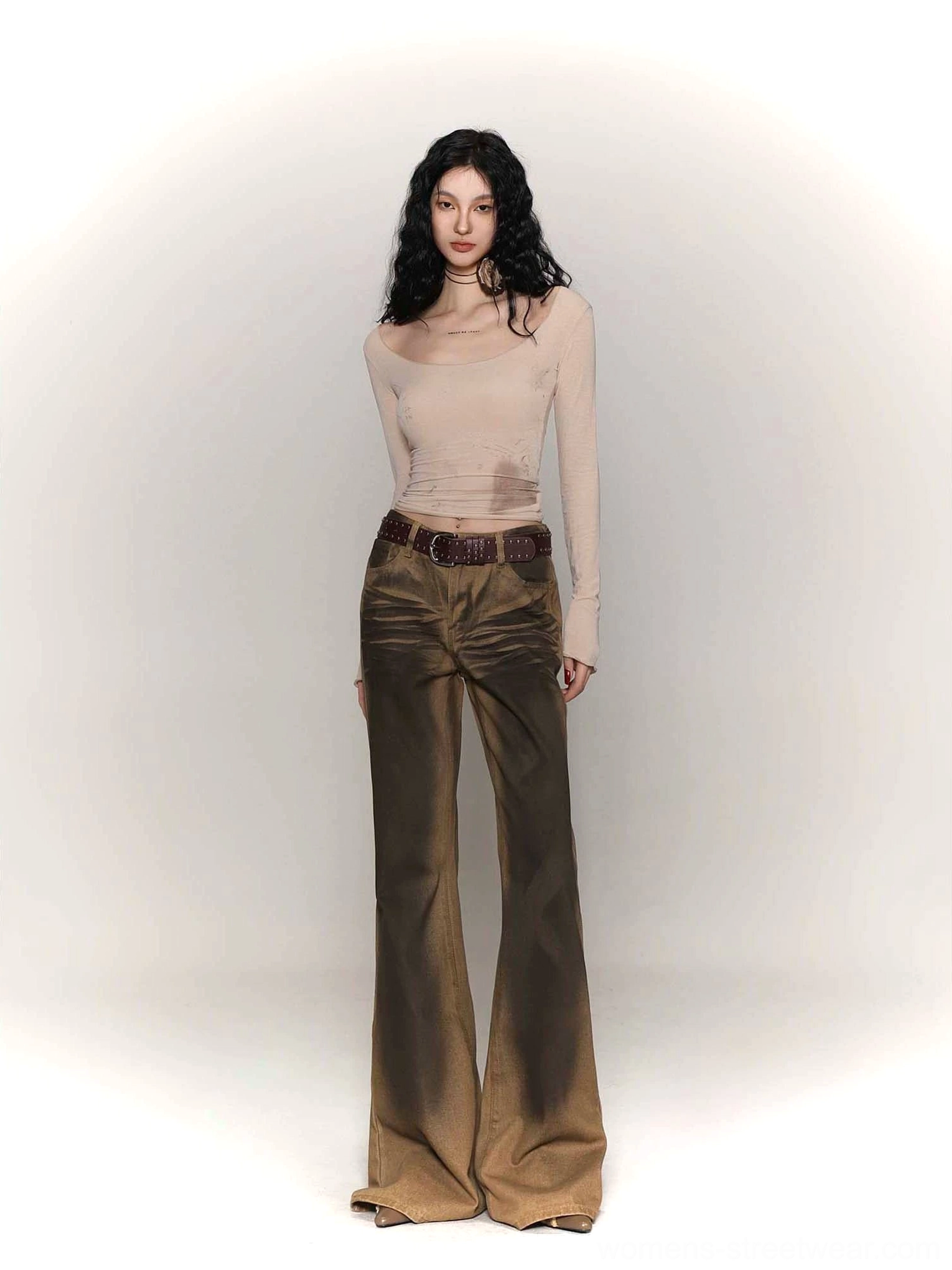 Female model wearing a light khaki tie-dye wide collar long sleeve streetwear base layer with vintage flared denim pants