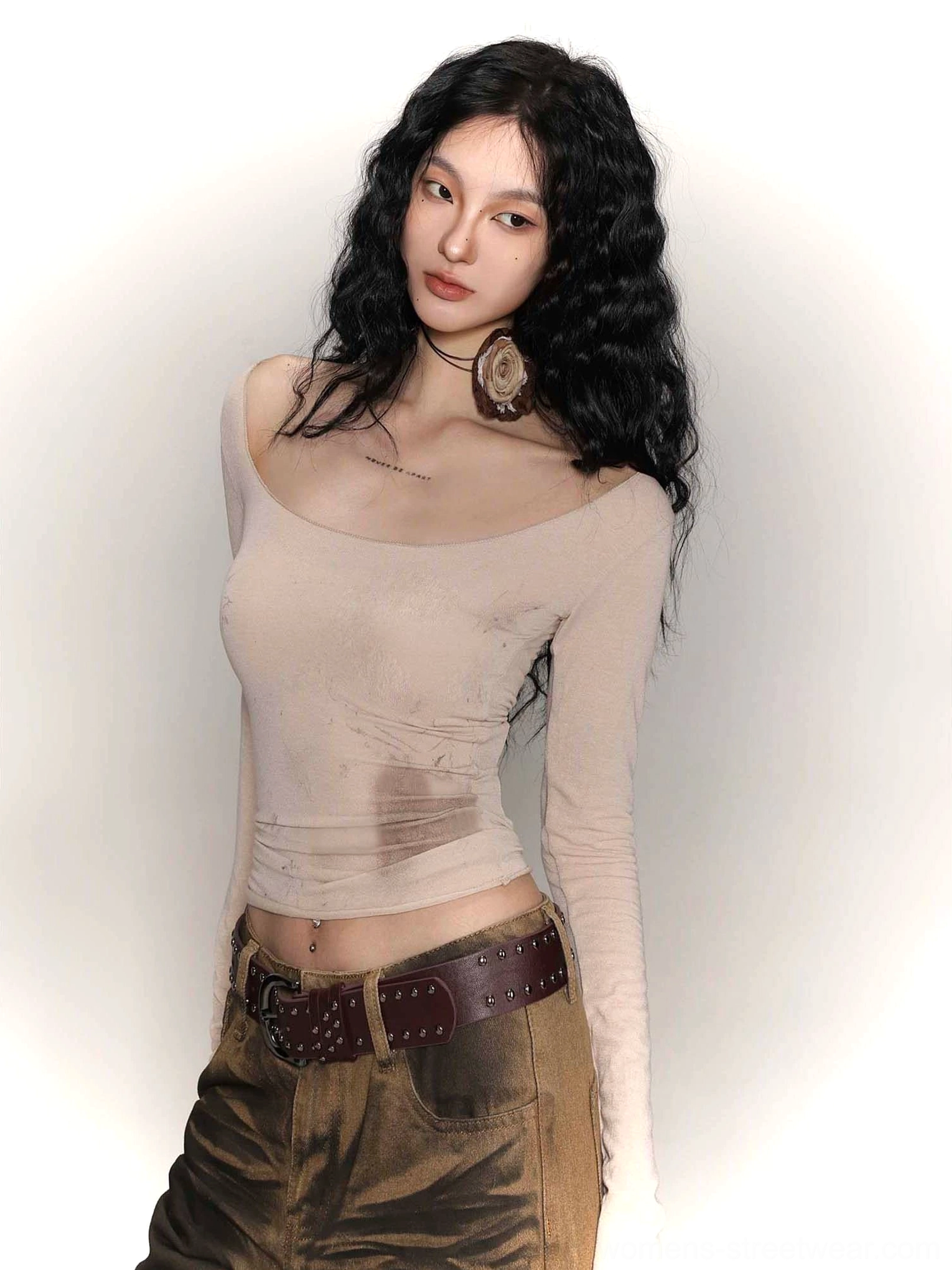 Close-up of fitted tie-dye wide collar base layer with vintage washed print and brown leather waist belt styling
