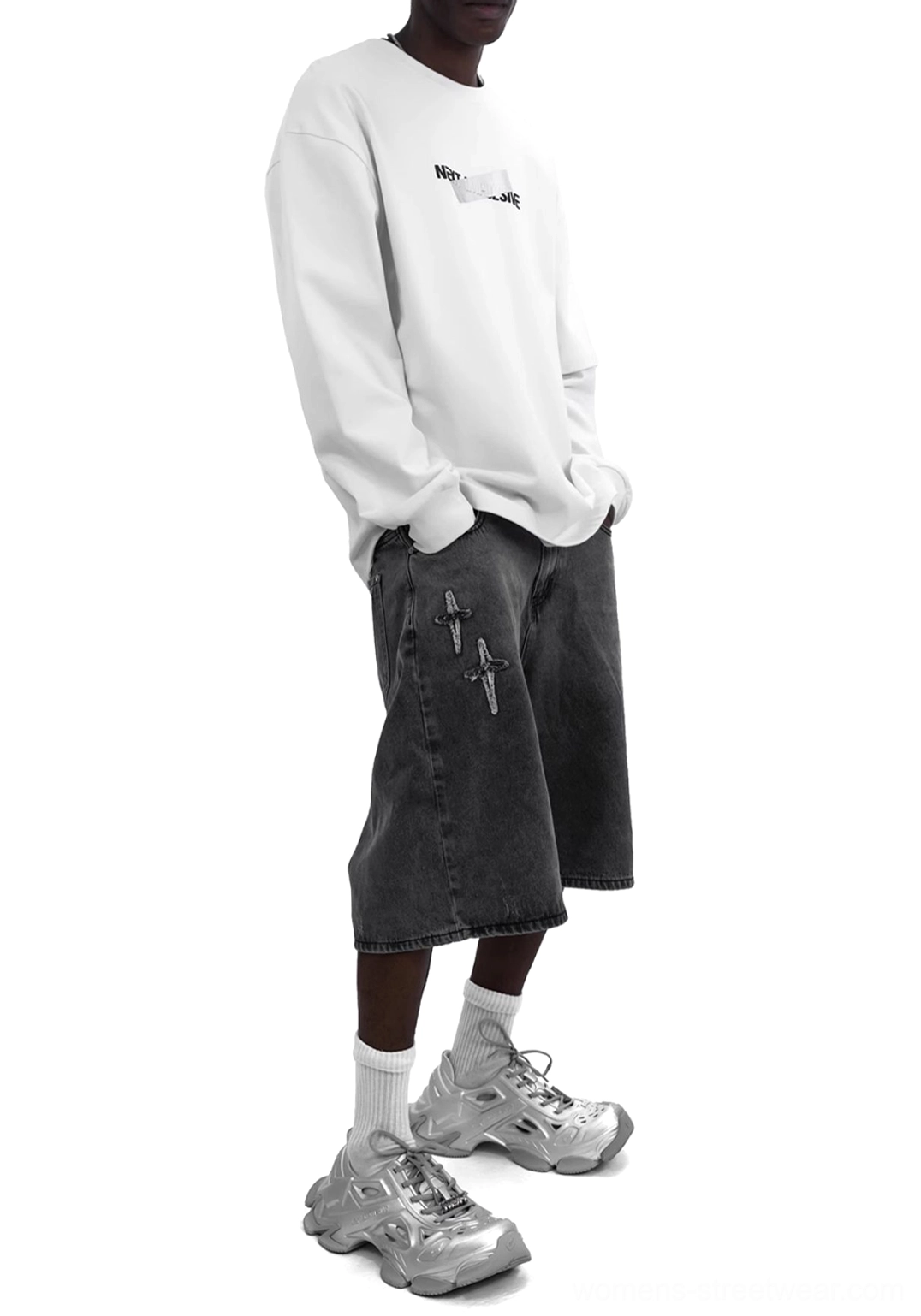 Metallic silver platform clog sneakers paired with black denim shorts in a futuristic casual streetwear outfit