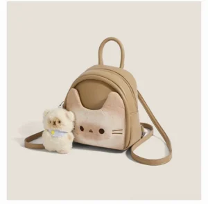 Front view of a cute toast beige cat mini backpack with embroidered eyes and whiskers, full zippered compartment, and fluffy puppy ornament with blue scarf