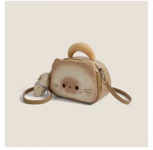 Cute toast cat mini handbag with padded top handle, zipper hardware and plush cat pendant on beige studio background