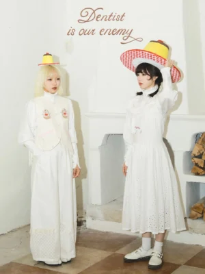 Pure white Tooth Fairy patchwork wide leg streetwear pants worn by female models in a retro dentist-themed studio