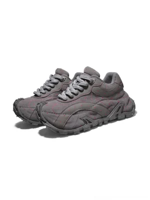 Pair of TrailGrid chunky sneakers in dark gray with round fabric shoelaces, reinforced toe caps, structured outdoor-inspired shape, and thick streetwear sneaker soles