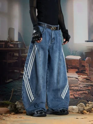 Front low-angle view of vintage blue triple-stripe balloon baggy jeans with curved seams and white sporty side stripes styled with dark Seoul streetwear