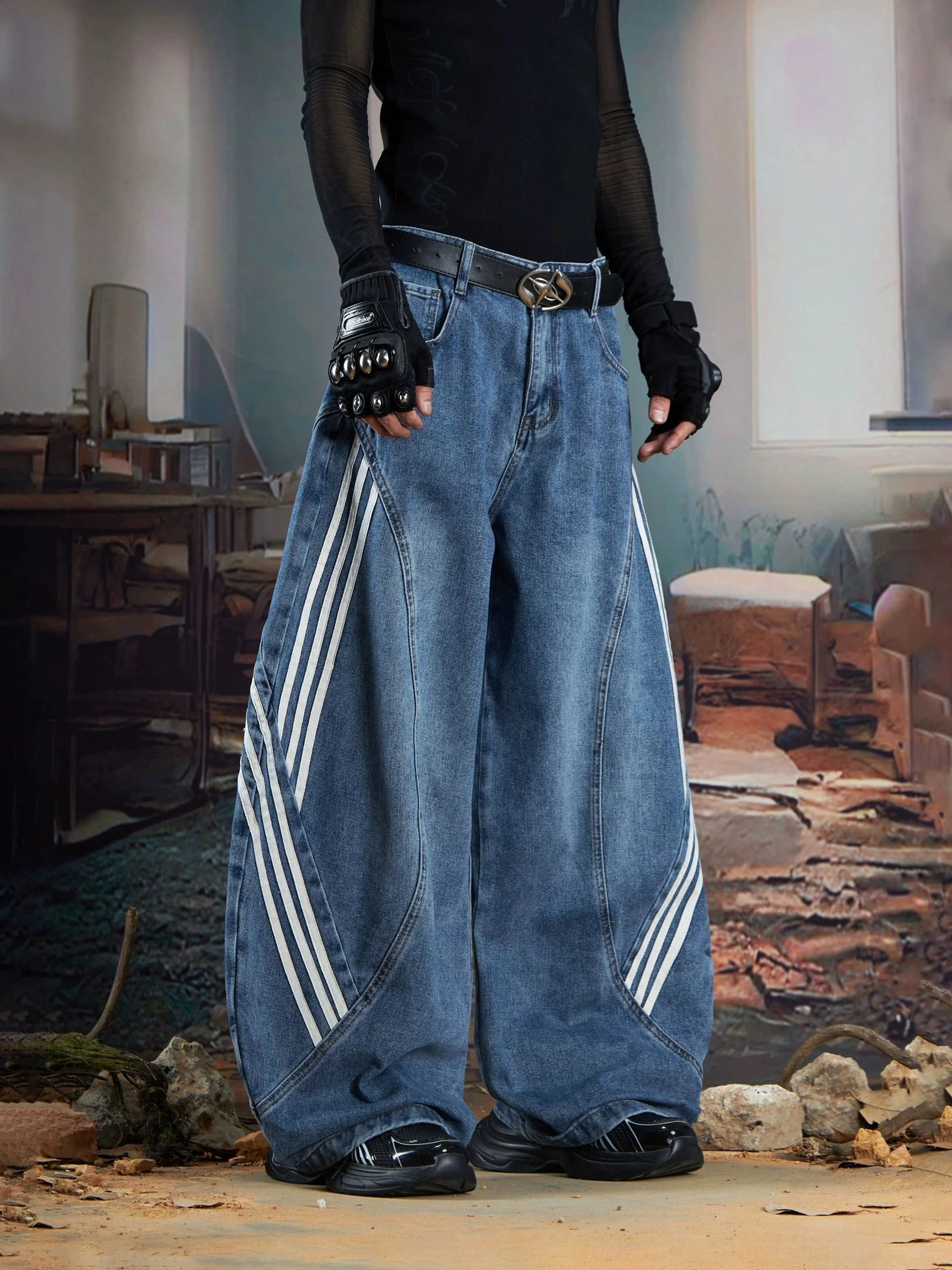 Front low-angle view of vintage blue triple-stripe balloon baggy jeans with curved seams and white sporty side stripes styled with dark Seoul streetwear