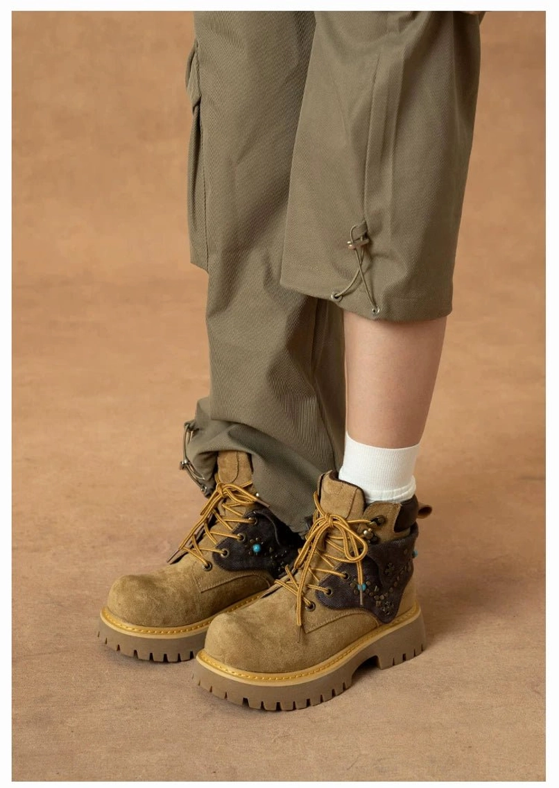 Front close-up of turquoise embellished western ankle boots with khaki cargo pants, white socks and chunky lug soles