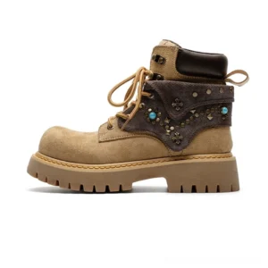 Yellow-brown turquoise embellished western ankle boots with chunky lug sole and decorative metal studs shown in left side studio view