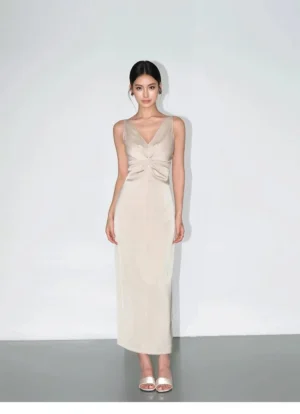 Champagne satin twist-front maxi slip dress shown in a full-body front view with V-neckline, sleeveless column silhouette and glossy ankle-grazing finish