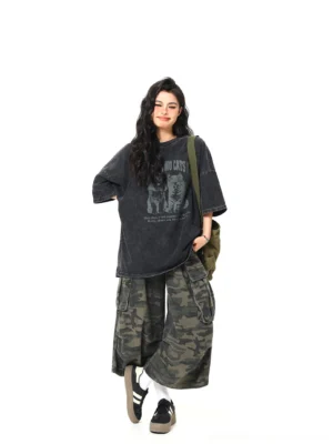 Side three-quarter view of black two cats washed oversized graphic tee with dropped shoulders and relaxed streetwear fit