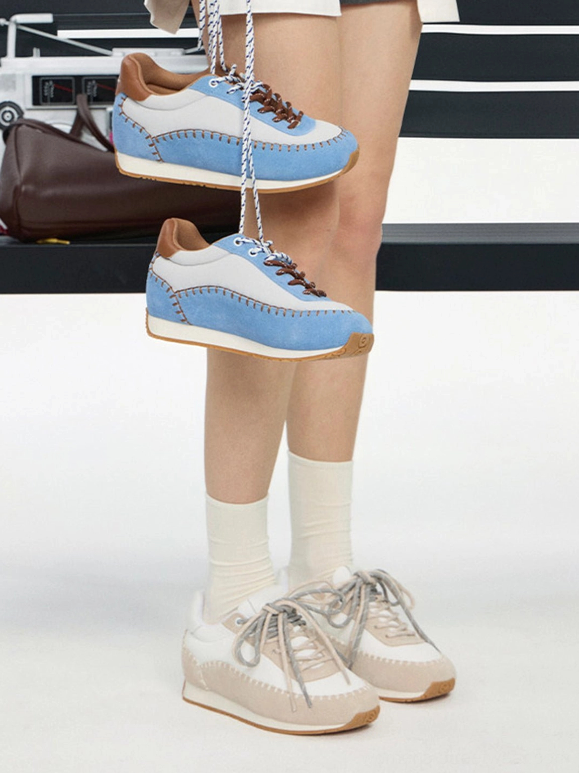 Two colorways of contrast-stitch platform sneakers shown from above with neutral and blue streetwear styling