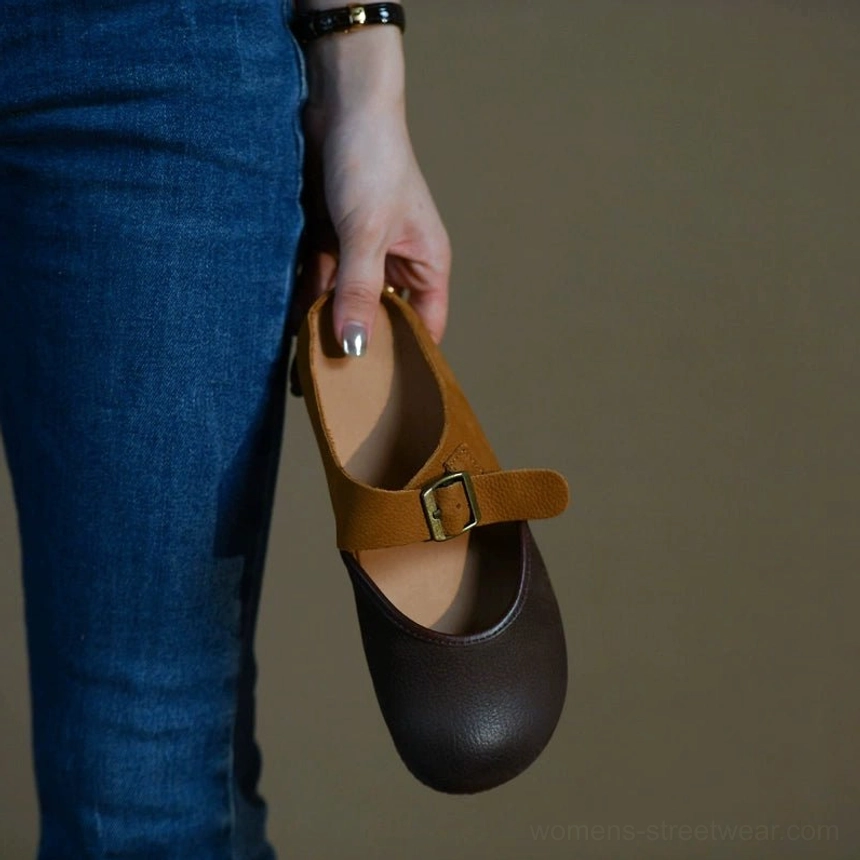 Brown and tan leather Mary Jane flats with rounded toe and adjustable buckle closure
