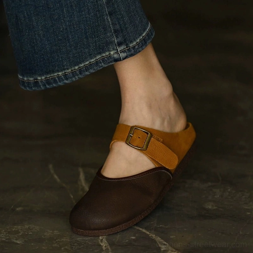 Brown leather Mary Jane flat worn with blue jeans showing the tan contrast buckle strap