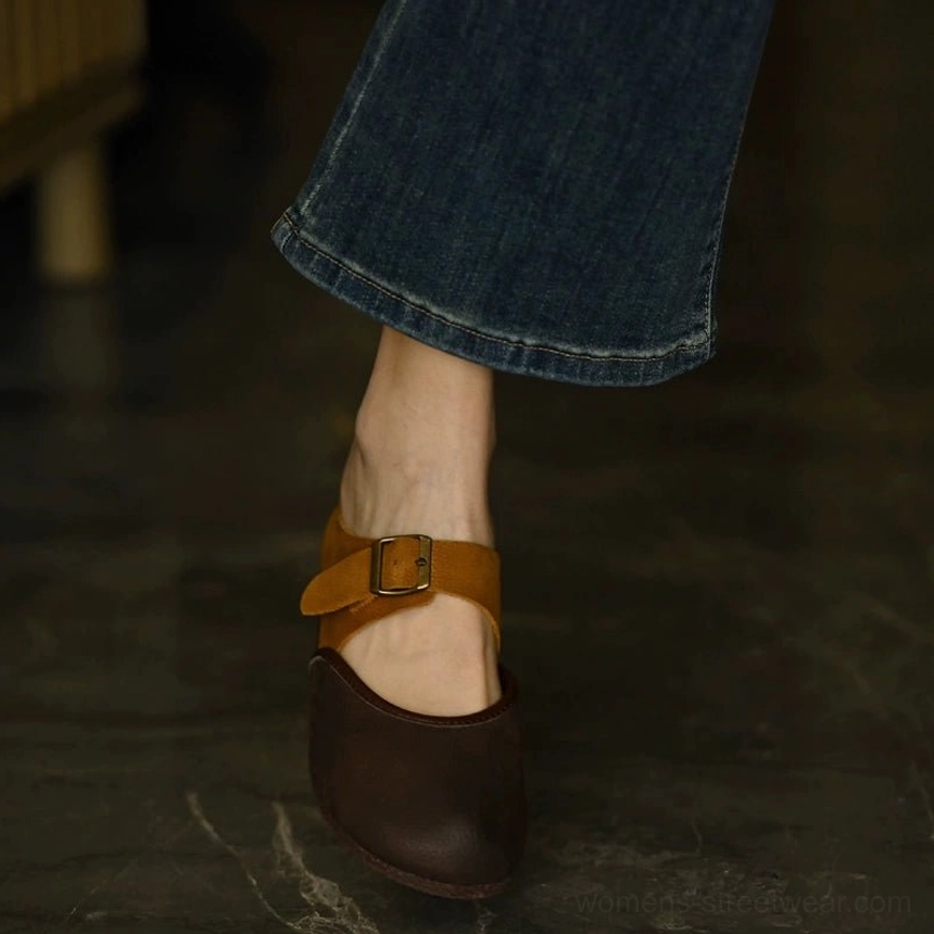 Rear side view of two-tone leather Mary Jane flats worn with jeans showing the tan ankle strap