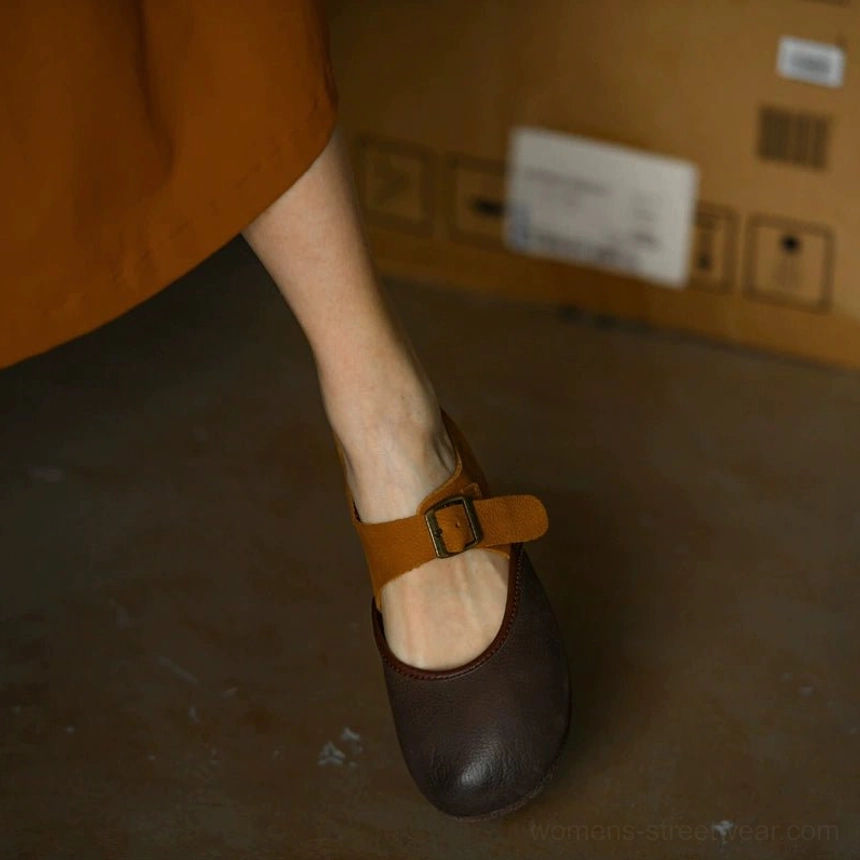 Side profile of two-tone brown leather Mary Jane flats with tan adjustable buckle strap