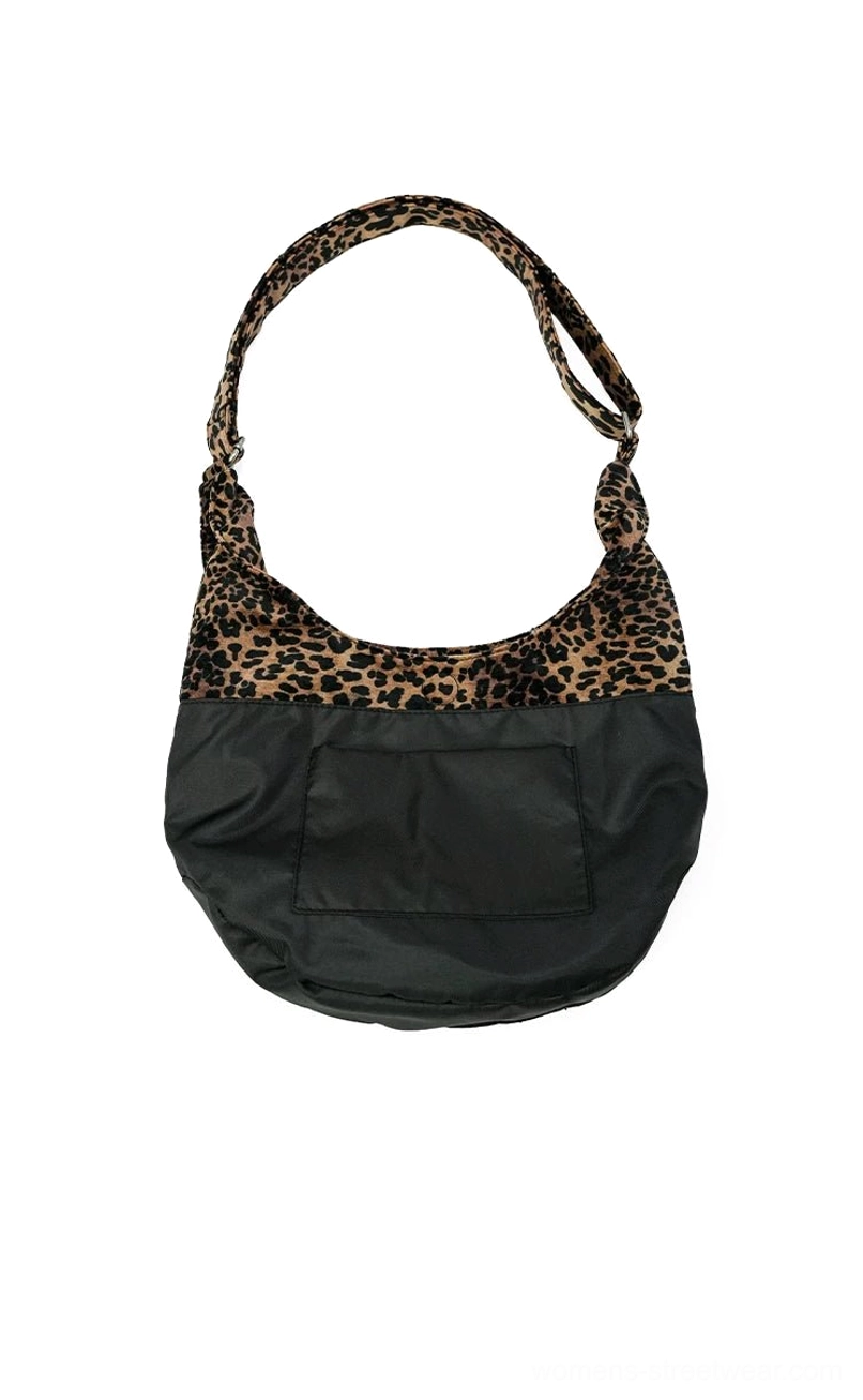 Two-tone leopard print hobo shoulder bag with black nylon body front pocket and adjustable animal print strap