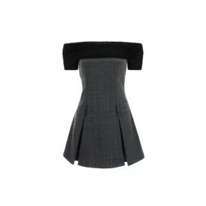 Flat lay of a two tone off shoulder plaid mini dress showing the black ruched top, tailored plaid bodice, and pleated mini skirt