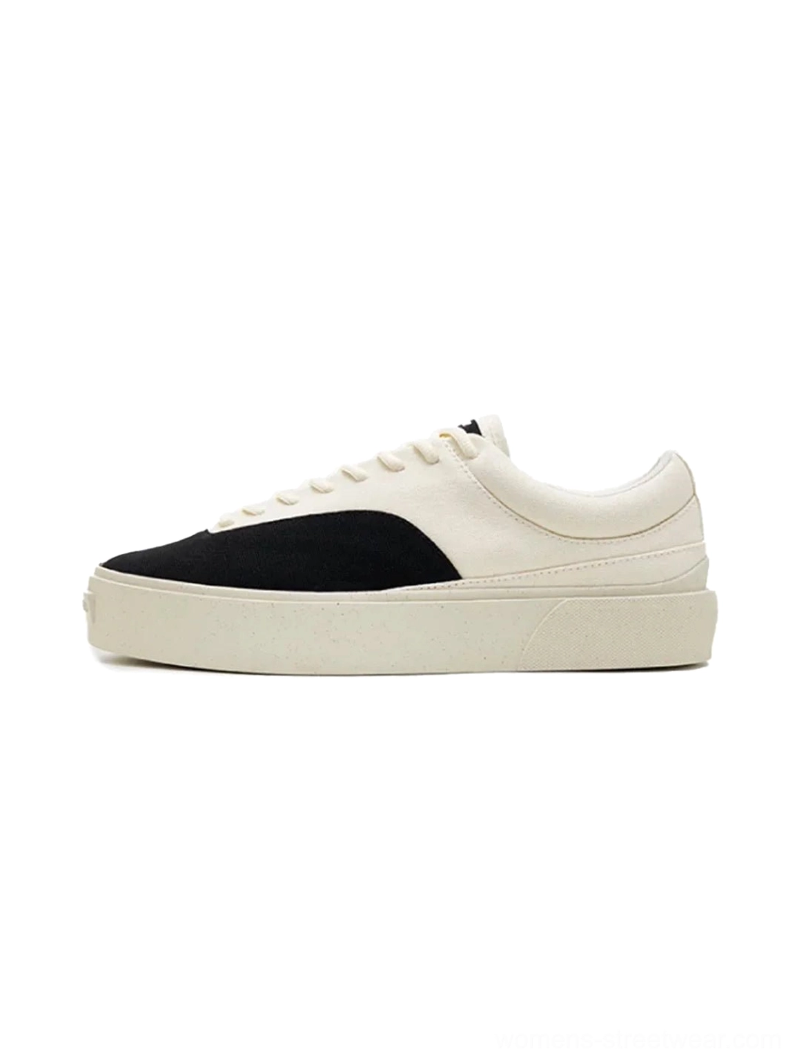 Side profile of egret white and black two-tone platform canvas skate shoes with thick speckled rubber sole and classic lace-up design