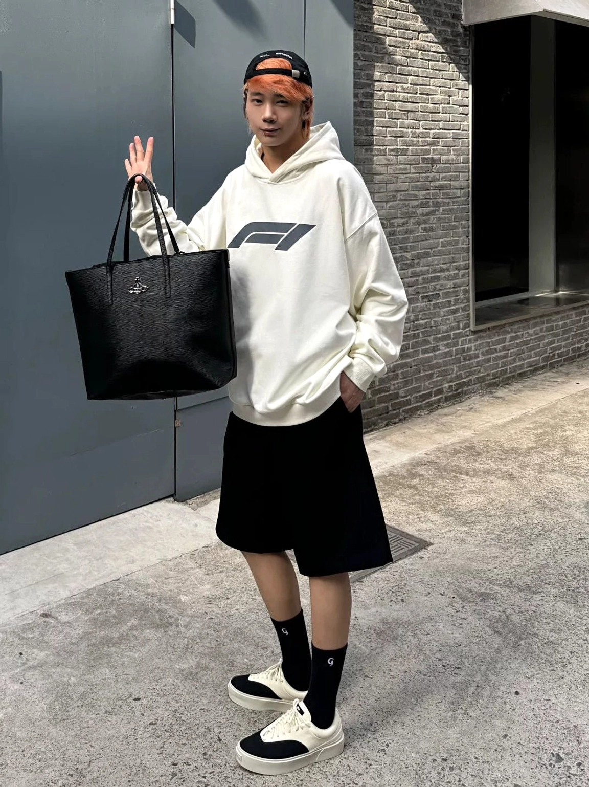 Full-body urban streetwear look featuring two-tone platform canvas skate sneakers styled with hoodie shorts socks and leather tote bag
