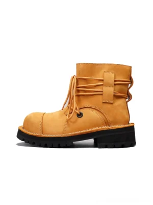 Tan leather utility ankle boots shown from the left front with wraparound laces, rear straps, rounded toe, and chunky anti-slip lug sole