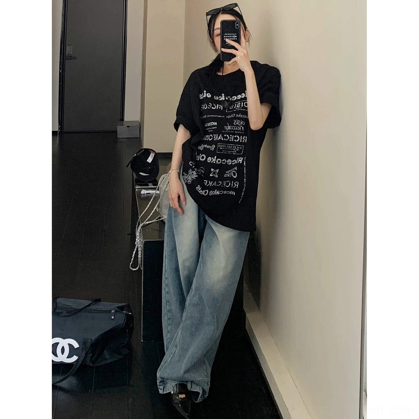 Black typographic riot oversized t-shirt full body streetwear styling with rolled short sleeves