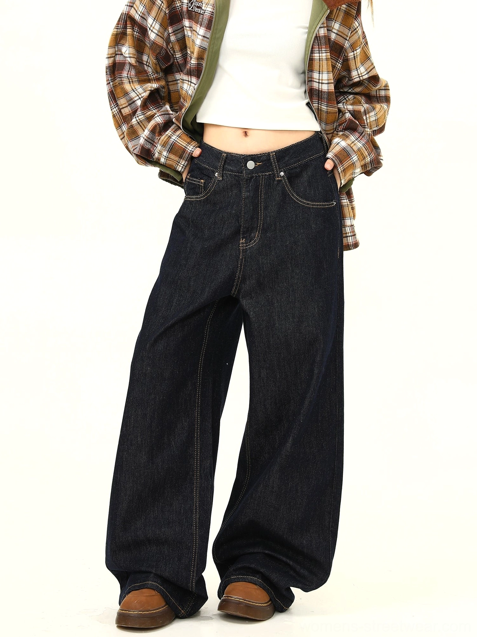 Front three quarter view of women wearing ultra wide leg mid waist dark denim jeans with contrast stitching and a relaxed Seoul streetwear silhouette