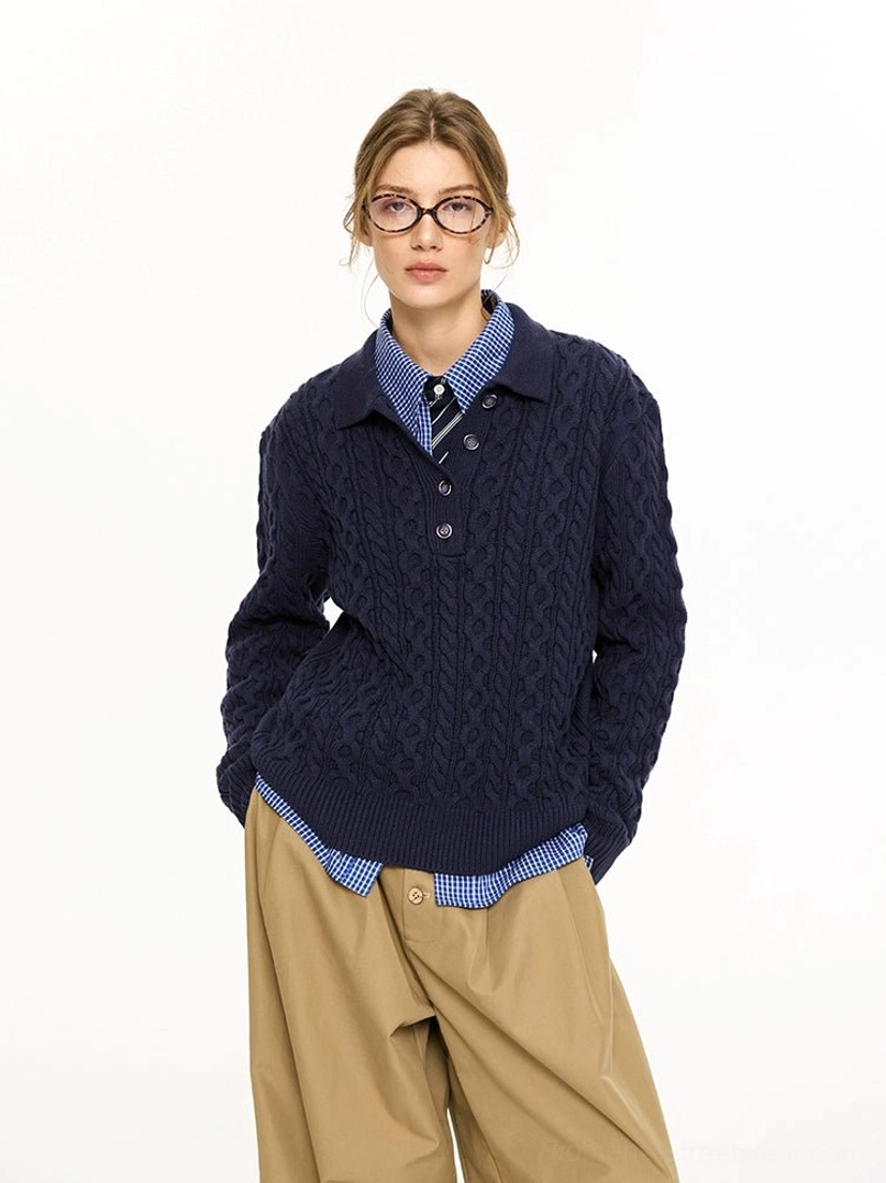 Navy blue cable knit polo collar sweater worn by female model with checkered shirt and khaki wide leg pants