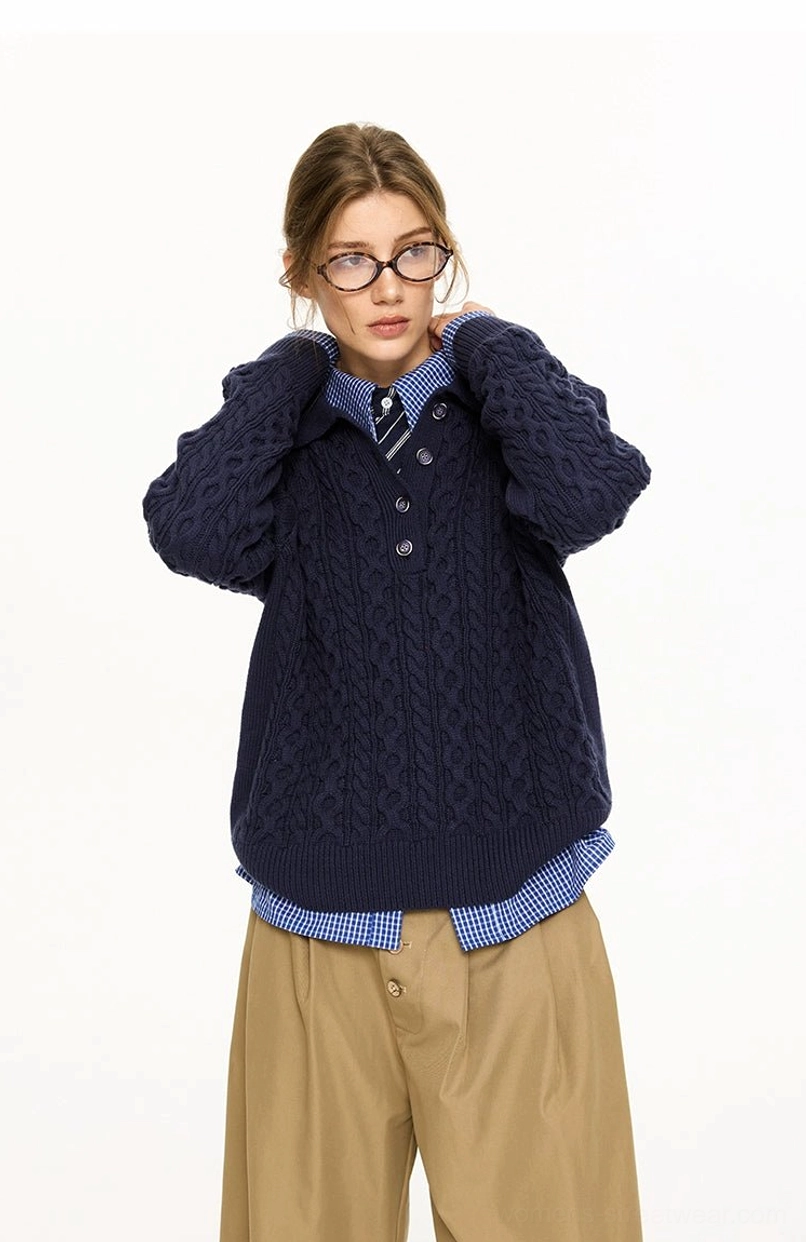 Female model adjusting the polo collar on a navy blue cable knit streetwear sweater