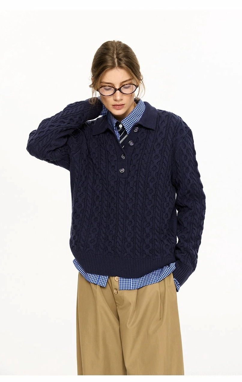 Navy blue cable knit polo collar sweater portrait view showing relaxed fit and textured cable pattern
