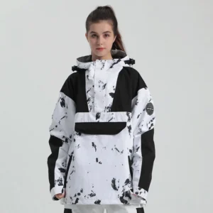 Female model wearing a black and white splatter color block hooded snowboard anorak jacket with front flap pouch pocket and relaxed unisex streetwear fit