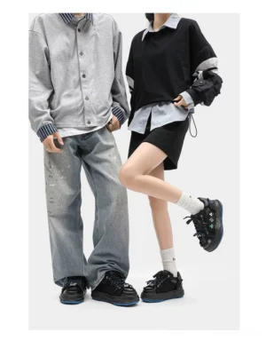 Unisex distressed embroidered platform sneakers styled on a couple wearing casual streetwear outfits, showing the black chunky platform sneaker silhouette in an everyday urban fashion look