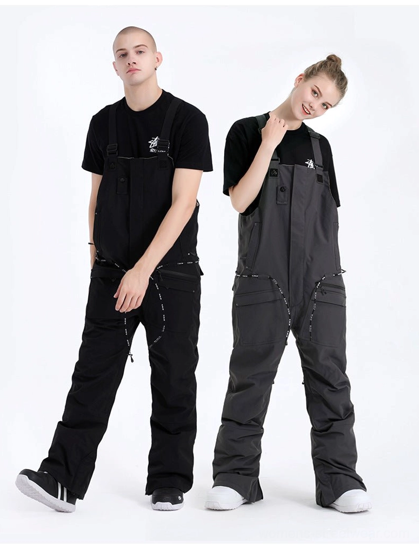 Unisex gray and black utility bib snow pants shown in side profile on male and female models for snowboarding and winter streetwear styling