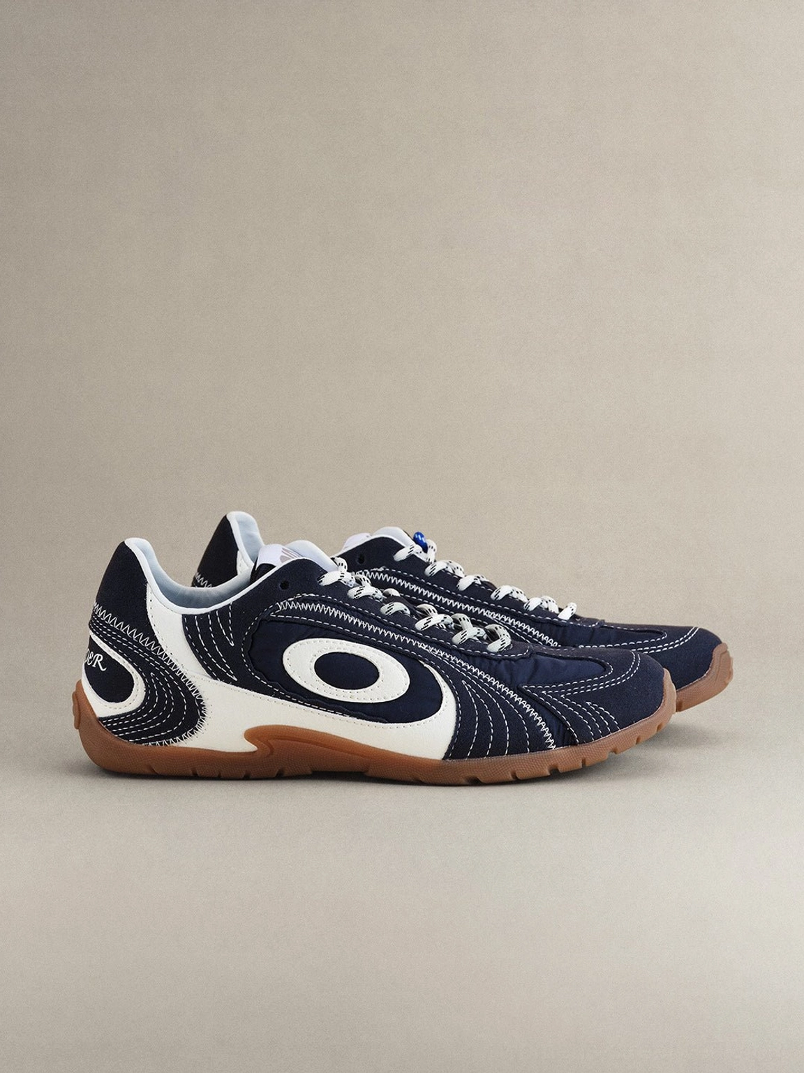 Unisex navy swirl-panel streetwear sneakers with layered overlays and a slim vintage-inspired gum outsole