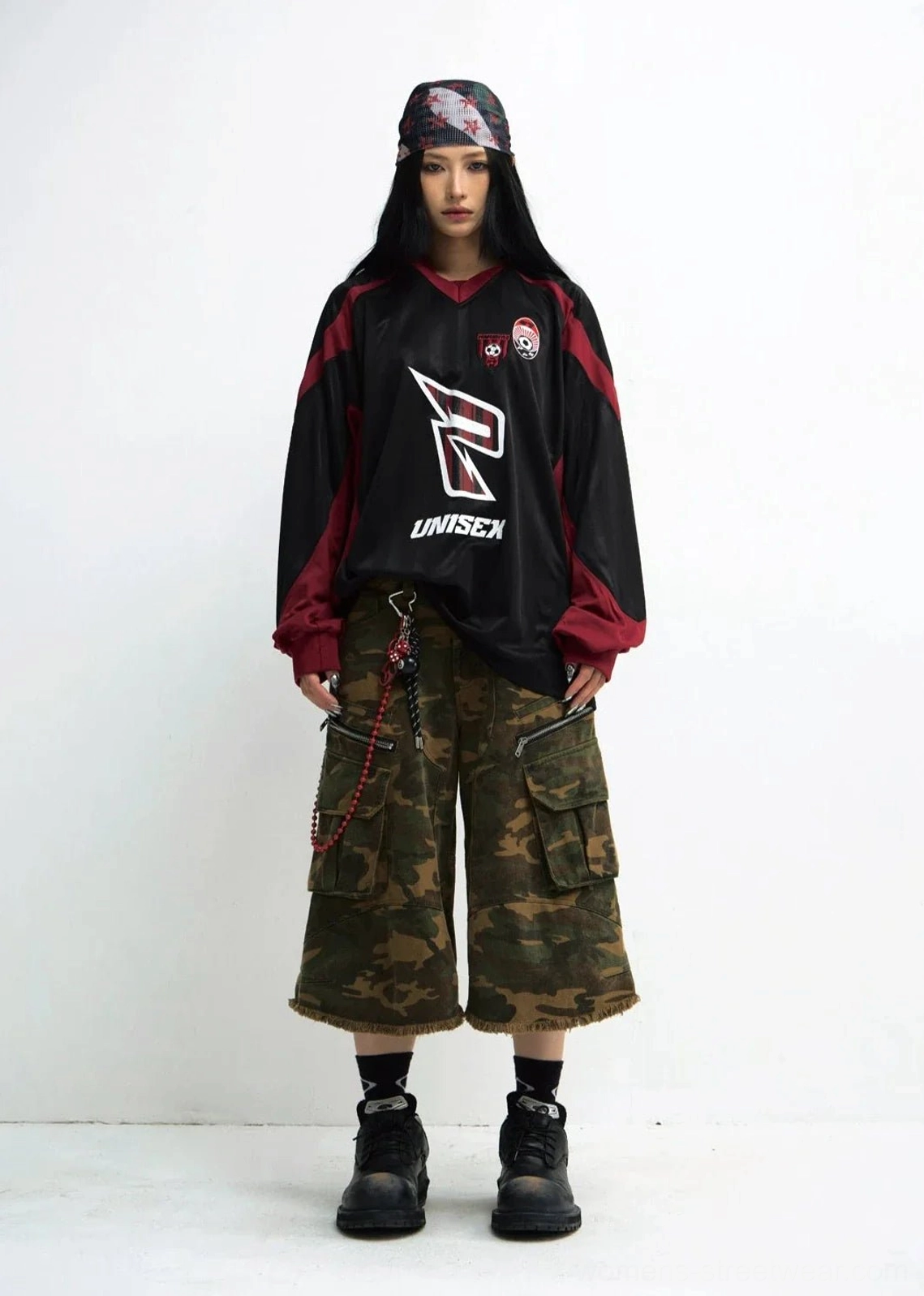 Unisex black and wine red racing team sweatshirt paired with camo cargo shorts and work boots on female model