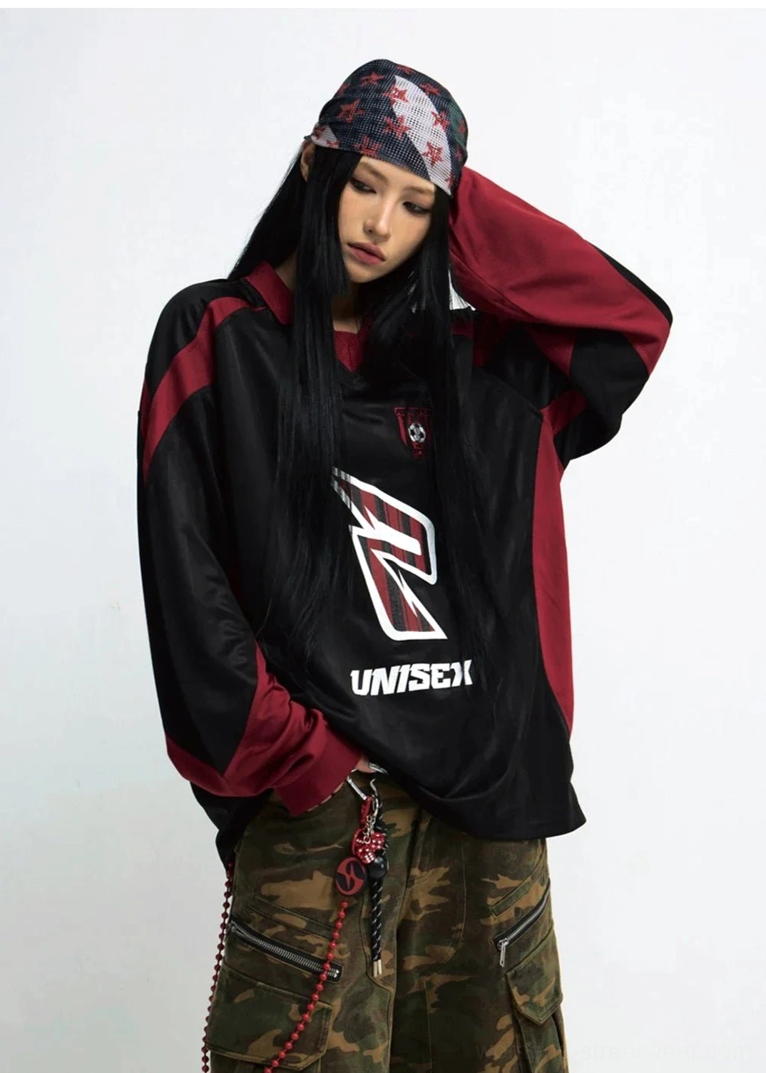 Female model wearing relaxed black and wine red racing team streetwear sweatshirt in front three quarter view