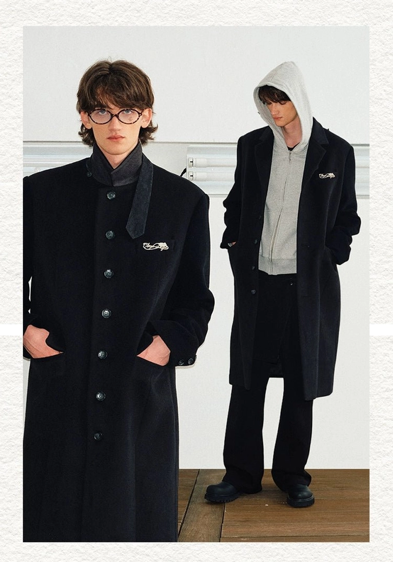 Black stand collar long overcoat styled two ways with high neck layering and a casual hoodie for Seoul streetwear