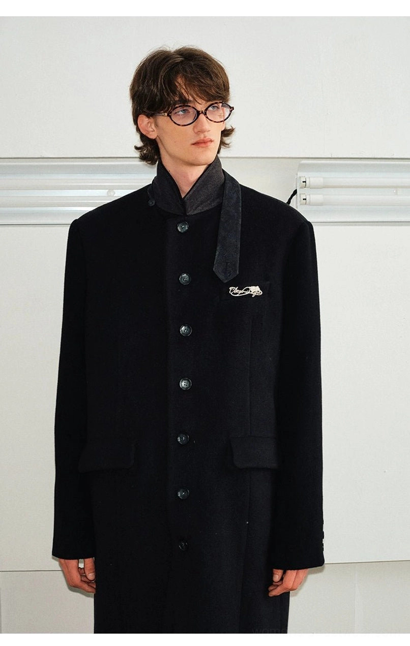 Black wool blend stand collar overcoat upper body view showing dark collar trim button placket and subtle chest detail