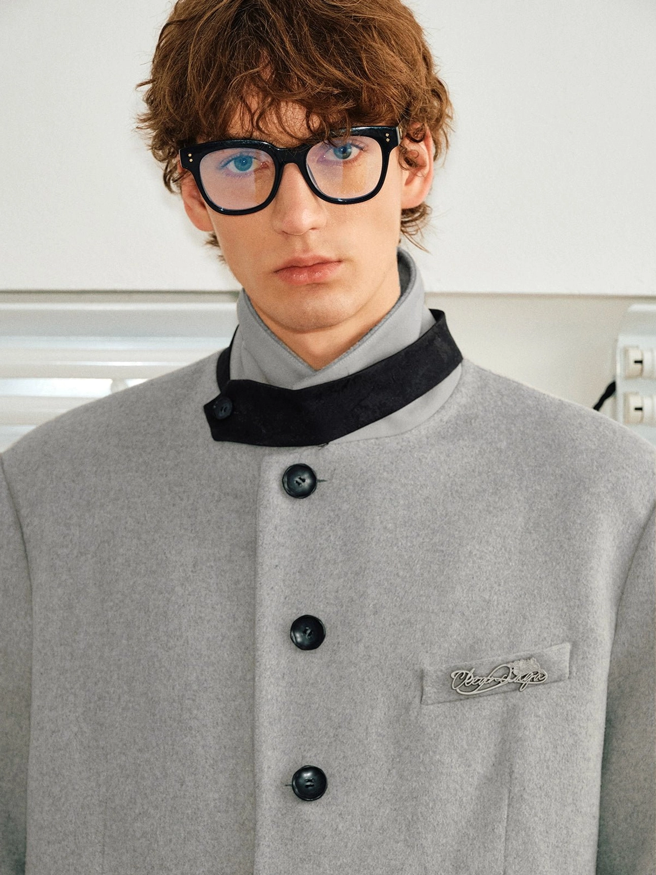Cloud Lime wool blend overcoat close-up showing contrast velvet stand collar trim black buttons and chest embroidery