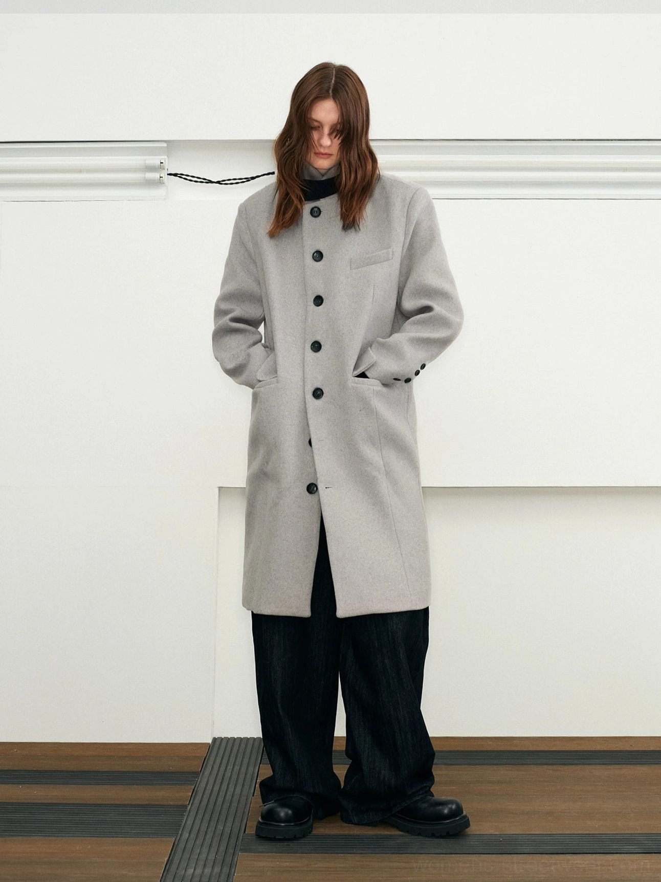 Cloud Lime long stand collar wool blend overcoat front view styled in a minimalist indoor studio
