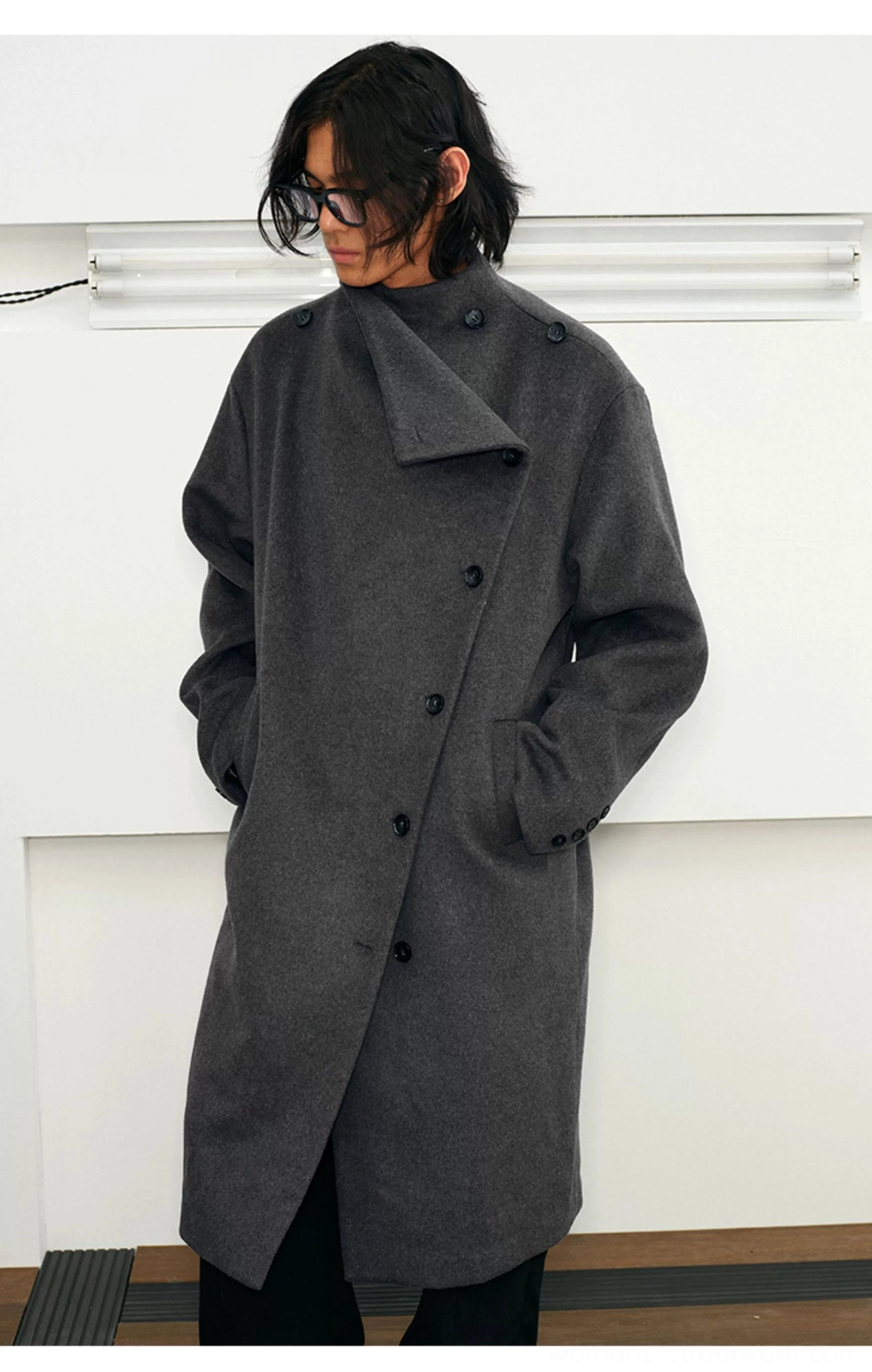 Gray-blue oversized wool blend overcoat side view showing asymmetric collar and longline streetwear fit