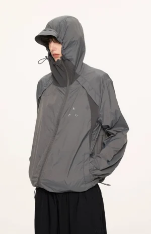 Dark gray UPF 50 lightweight sun protection hooded techwear jacket shown in left side full body streetwear view