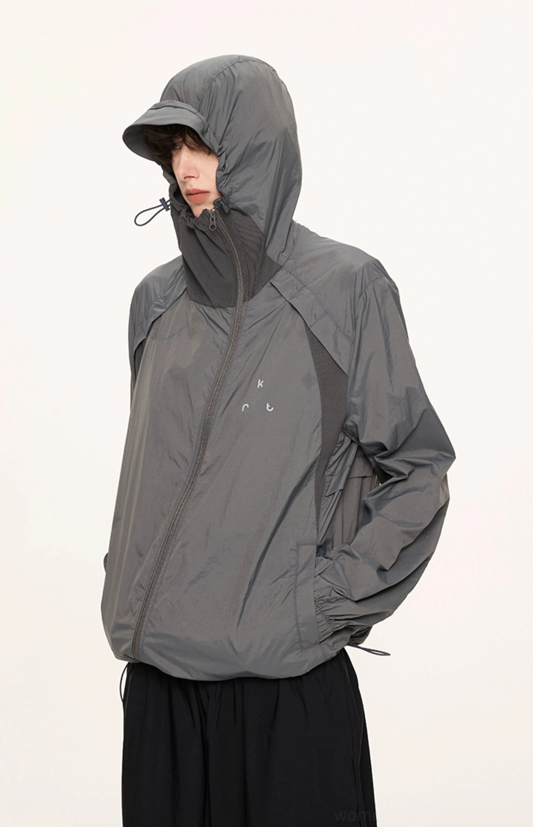 Dark gray UPF 50 lightweight sun protection hooded techwear jacket shown in left side full body streetwear view