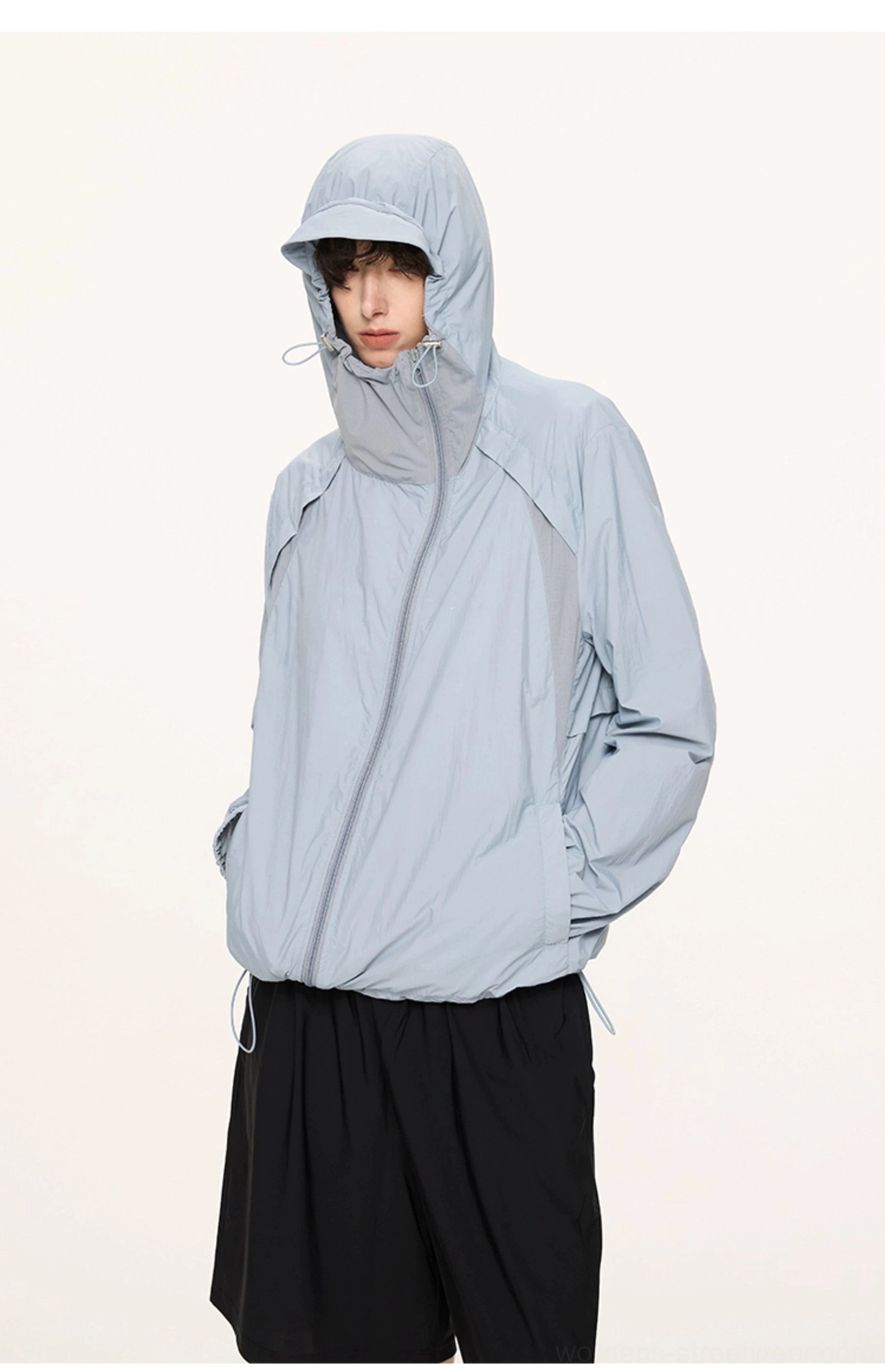 Dusty blue UV protection hooded techwear jacket front half body view with hood up and lightweight shell