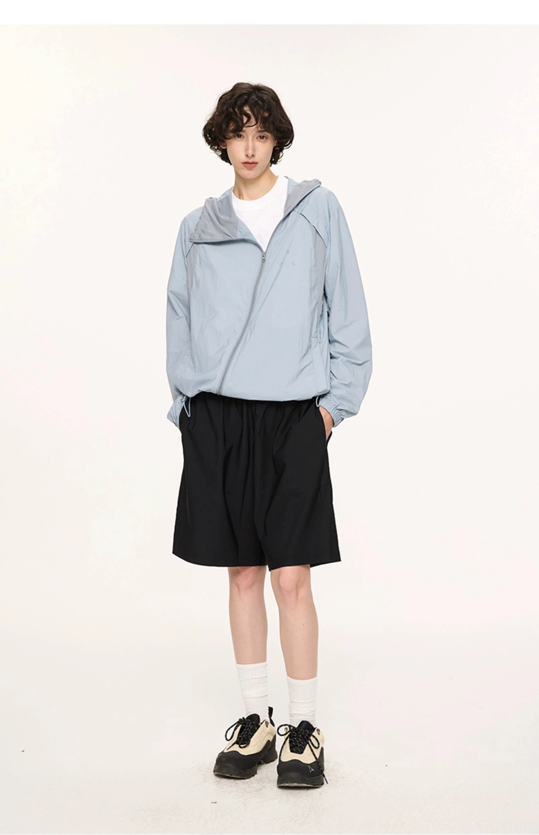 Dusty blue lightweight UPF 50 sun protection jacket worn open at the hood with stand collar and full zip