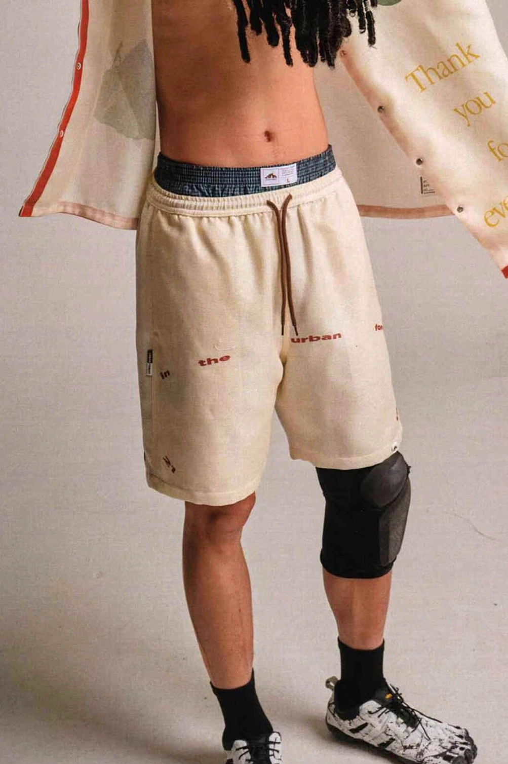 Apricot Urban Forest graphic sweat shorts rear view showing elastic drawstring waistband and relaxed fit