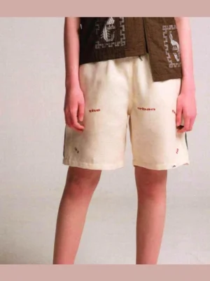 Apricot Urban Forest graphic sweat shorts front view with relaxed loose streetwear fit and minimal text print