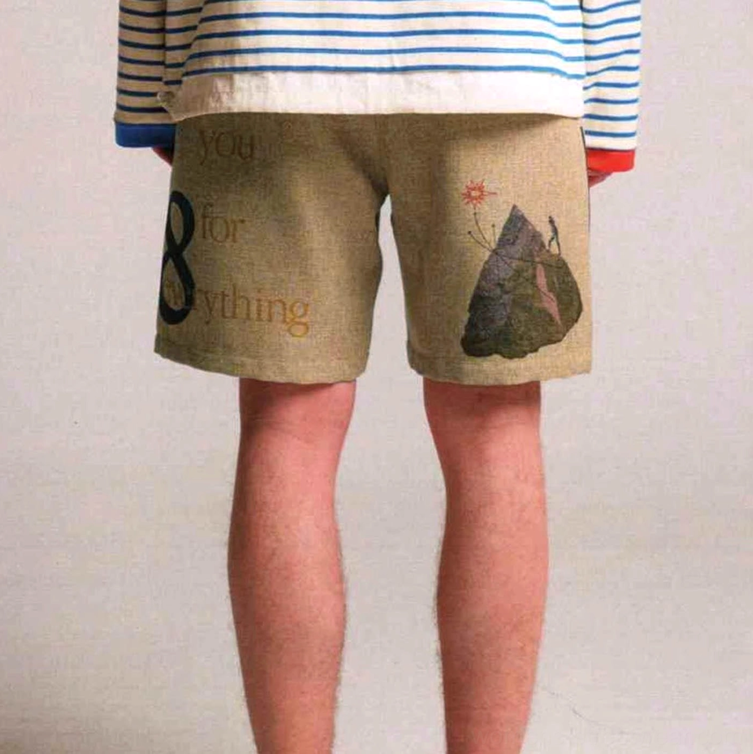 Khaki Urban Forest graphic sweat shorts back view featuring number 8, mountain artwork, and text print