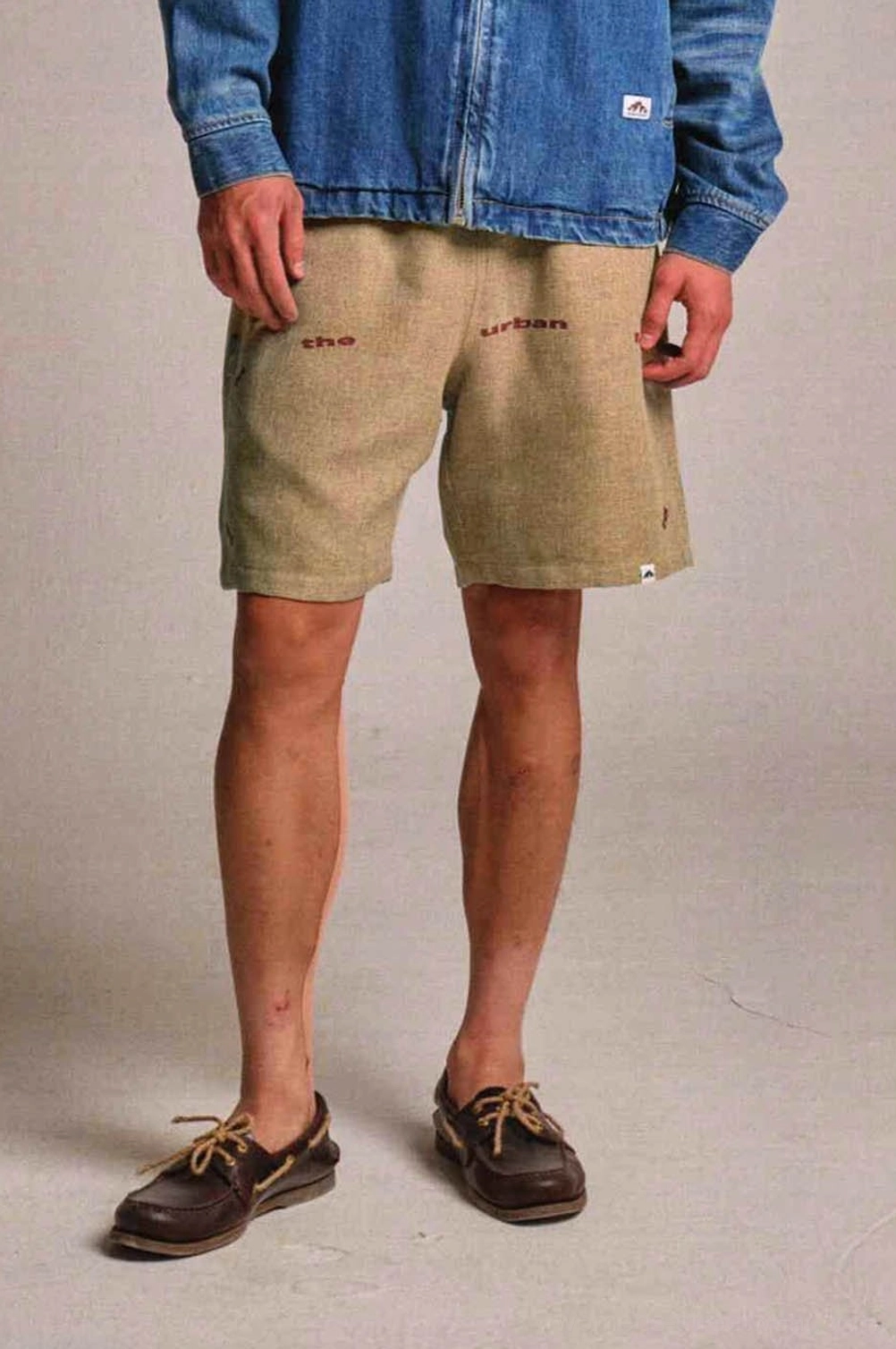 Khaki Urban Forest graphic sweat shorts styled with denim jacket in a loose Korean streetwear look